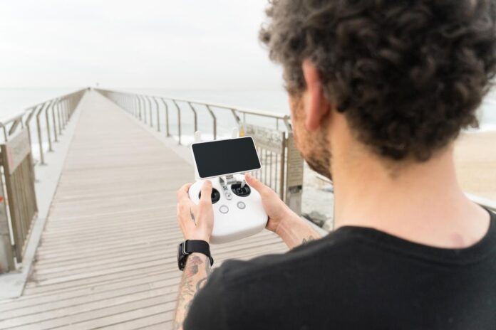 technologically-savvy-hipster-young-generation-millennial-professional-photographer-uses-remote-control-pilot-drone-quadrocopter-gadget-air